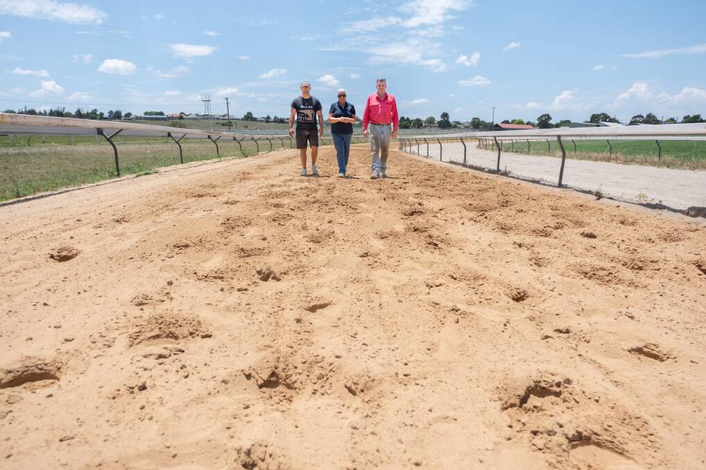 Shane Adams, Bathurst Thoroughbred Racing manager Lisa Pierce and John Condon walking along the new sand track. Picture by James Arrow.