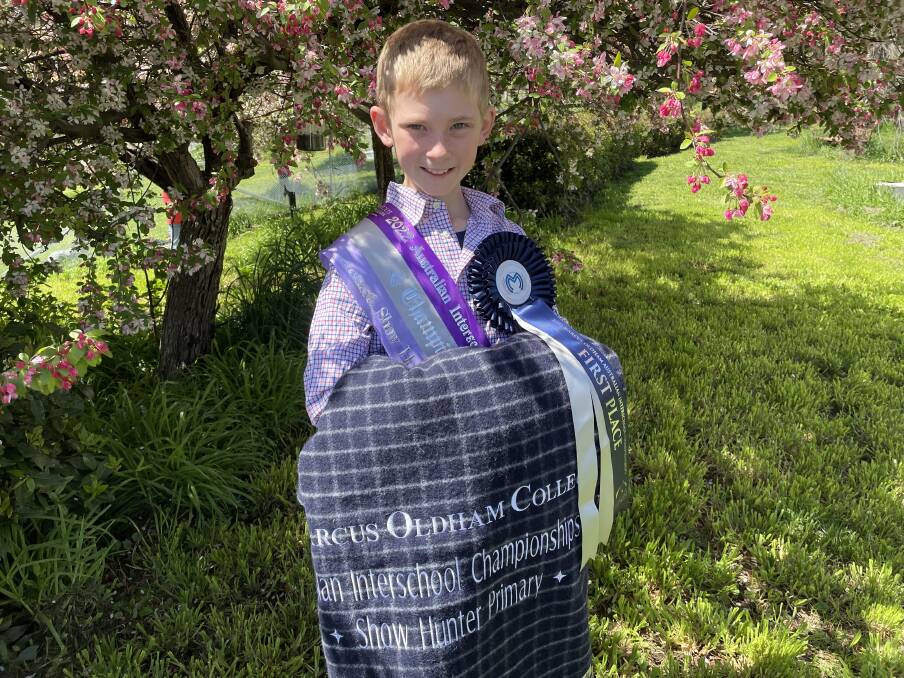 Harrison Galloway-Smith with his first place ribbon and sash, and the blanket he received for overall highest point scorer in the Australian Interschool Championship Show Hunter Primary events. Picture by Alise McIntosh