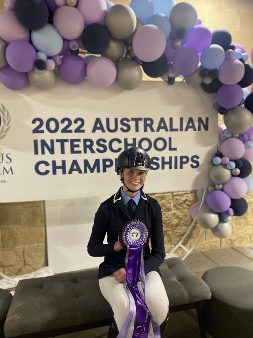 Molly Corbett holding her fifth place ribbon at the 2022 Australian Interschool Equestrian Championships. Picture supplied