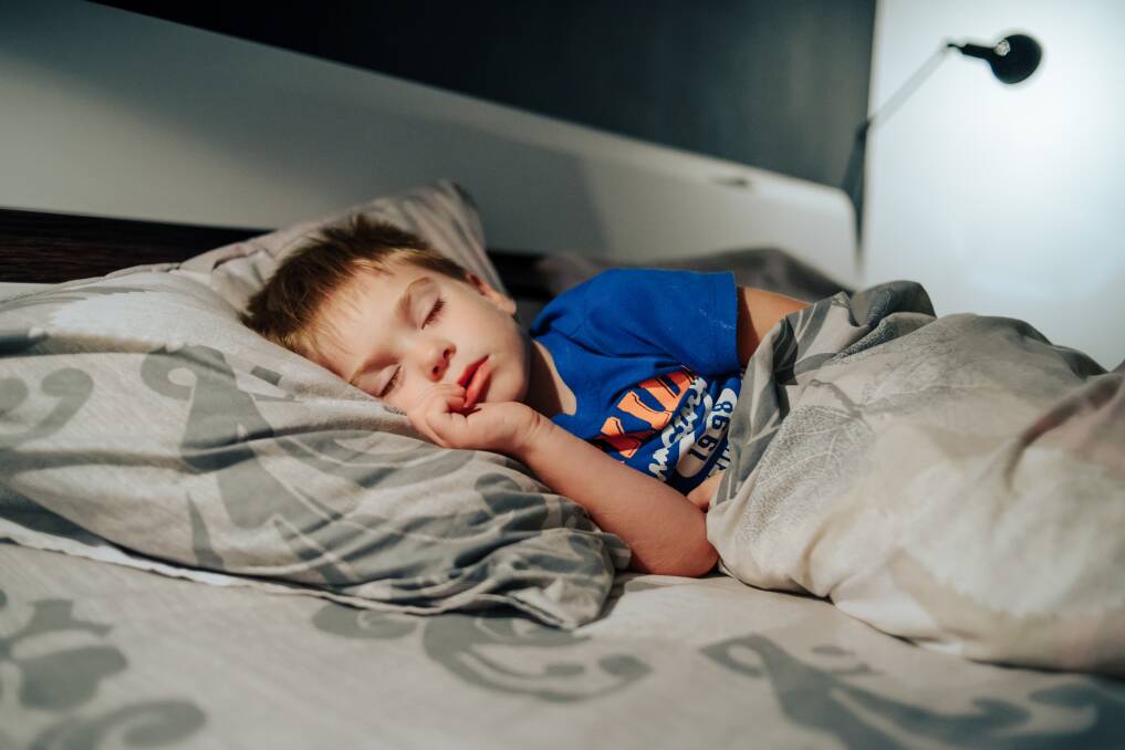 A boy asleep in bed. Picture from shutterstock. 