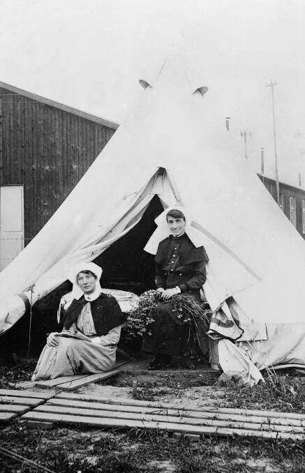 ABOVE AND BEYOND: Sister Nellie Morrice (right) outside her tent at No. 3 Australian General Hospital in Abbeville, France, in 1917. Nellie's tour of duty began in 1914 and did not end until 1919. Photo: AWM H16063