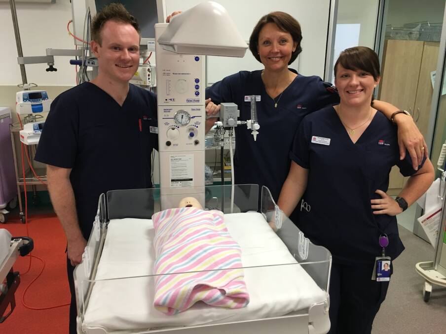 DONATION: Nurses James Adam, Trish Comiskey and Nicole Harrison, with the new basic infant resuscitation cot. Photo: BRADLEY JURD