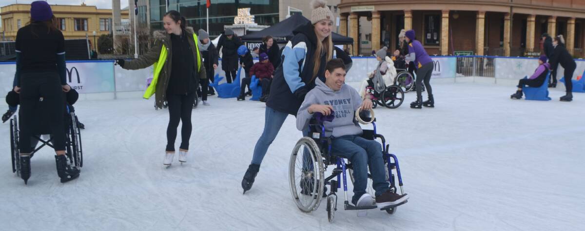 FUN ON THE ICE: Alexa Wensley helps Scott Griffiths around the ice at the Bathurst Winter Festival's Accessibility Day. Photo: BRADLEY JURD