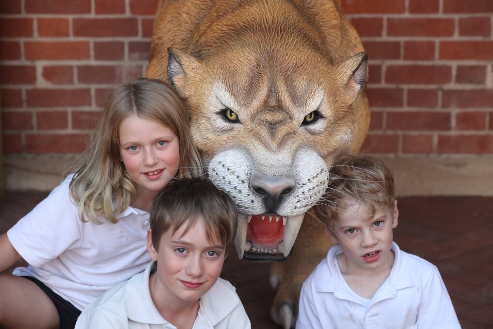 HOLIDAYS: Cordelia, Alastair and Edmund McLean aren't expecting to meet a sabre toothed tiger on Zoomobile Kids Day on Saturday. Photo: PHIL BLATCH