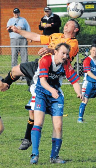 A Macquarie United player jumps high for a header against Young Lions in the 2010 Bathurst District Football men's grand final. Photo: ZENIO LAPKA 