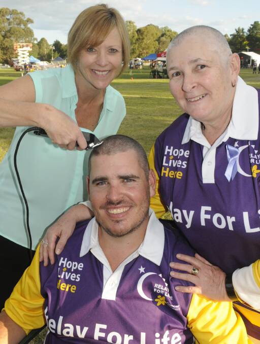 HAIR OFF: Leesa Feenan shaved the heads of mother and son duo Wes and Karen Nixon during the Relay for Life. Photo: CHRIS SEABROOK 031117crelay13a