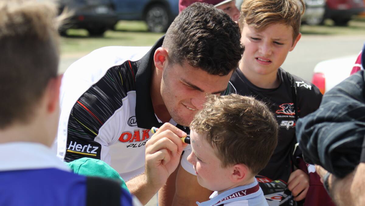 FANS: Nathan Cleary signs the forehead of Holy Family student Austin Chenhall at the Peachy-Richardson Gala Day back in 2019. Photo: BRADLEY JURD