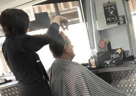 NEW STRICT RULES: Bathurst Barbers owner Sam Peacock at work cutting a client's hair. Photo: SUPPLIED