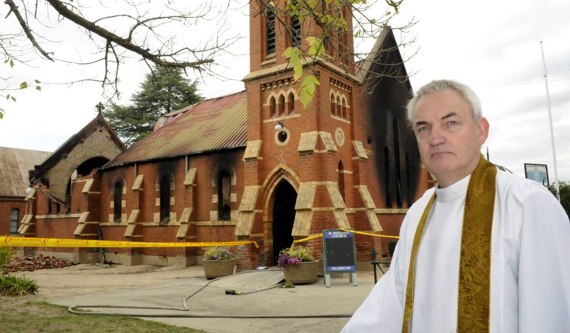 DEVASTATION: The Very Reverend James Hodson outside St Barnabus Anglican Church back in 2014 after a fire destroyed the church. Photo: CHRIS SEABROOK 022314church2
