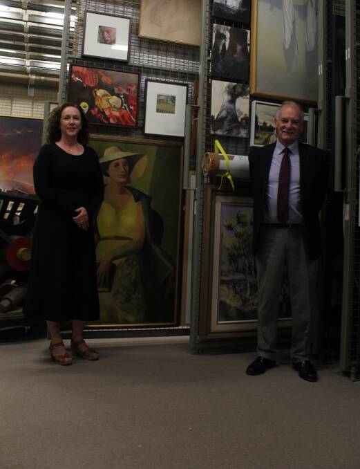 ARTWORK: Bathurst Regional Art Gallery director Sarah Gurich, with BRAGS president Max Wilson, with some of the society's collection of artwork. Photo: BRADLEY JURD