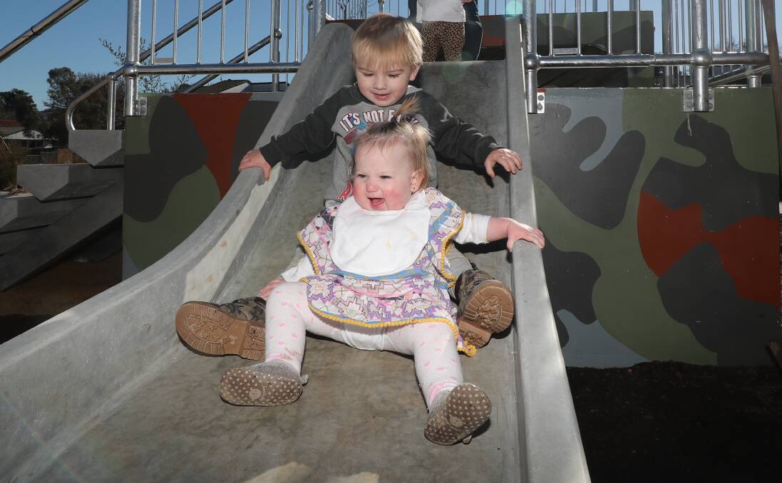 Phillip Corner and Frankie Pittman enjoy the slide at the new Kelso Community Hub outdoor recreational space on Wednesday morning. Photo: PHIL BLATCH