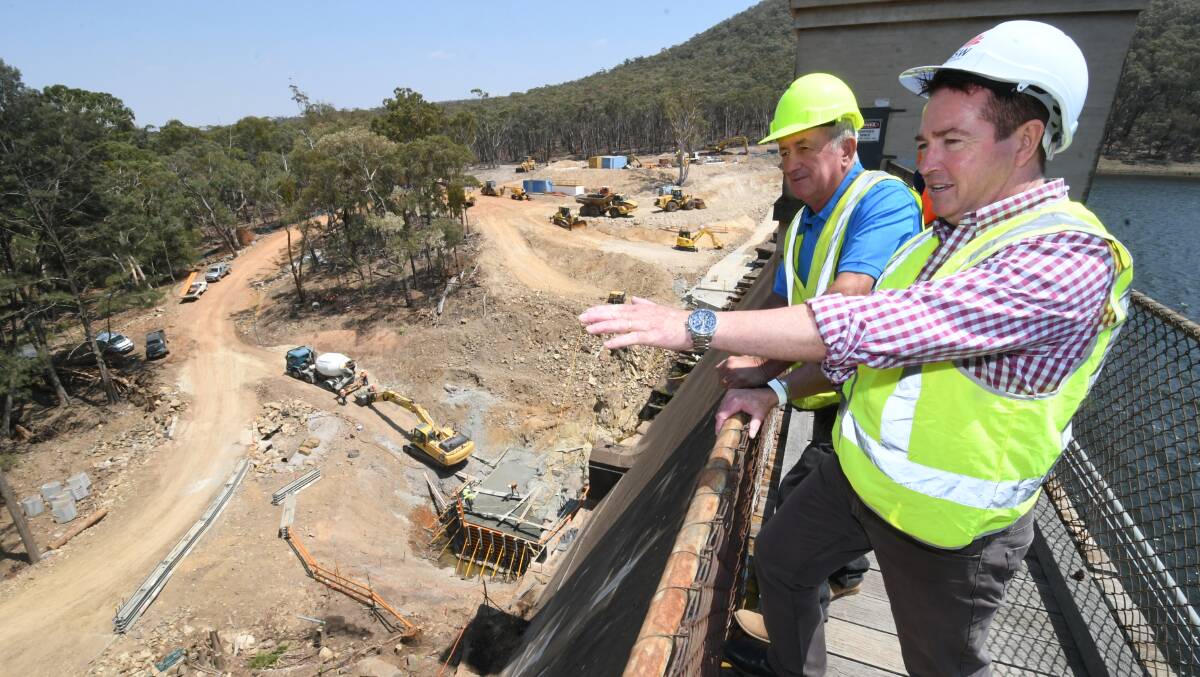 FULL STEAM AHEAD: Bathurst mayor Bobby Bourke with MP Paul Toole checking out the progress to strength the Winburndale Dam wall on Monday. Photo: CHRIS SEABROOK 011320cwindam1