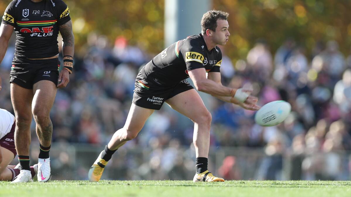 FULL CROWD: Penrith fullback Dylan Edwards throws a pass in last year's NRL match. Photo: PHIL BLATCH