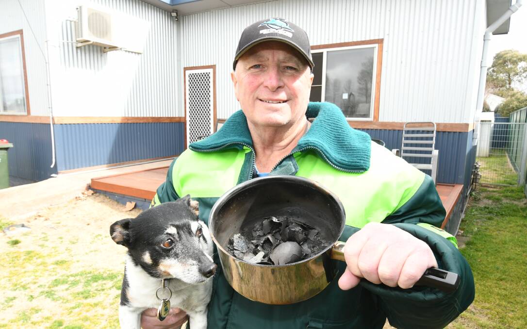 BOILED DRY: John Meagher with his best friend Jack and the burnt saucepan. Photo: CHRIS SEABROOK. 082119ceggs
