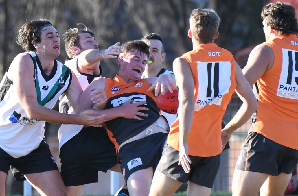 TACKLED: Bathurst Giants' Sam Sloan is crunched in a tackle in Saturday's men's tier one match against Bushrangers. Photo: CHRIS SEABROOK