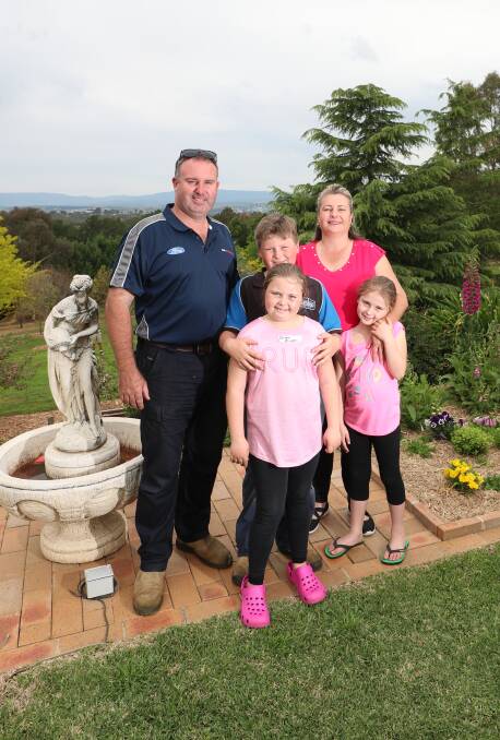 SPRING TIME: Karen and Scott Mitchell with children Brendan, Olivia and Amelia at Belvedere, one of the gardens in the Bathurst Spring Spectacular. Photo: PHIL BLATCH