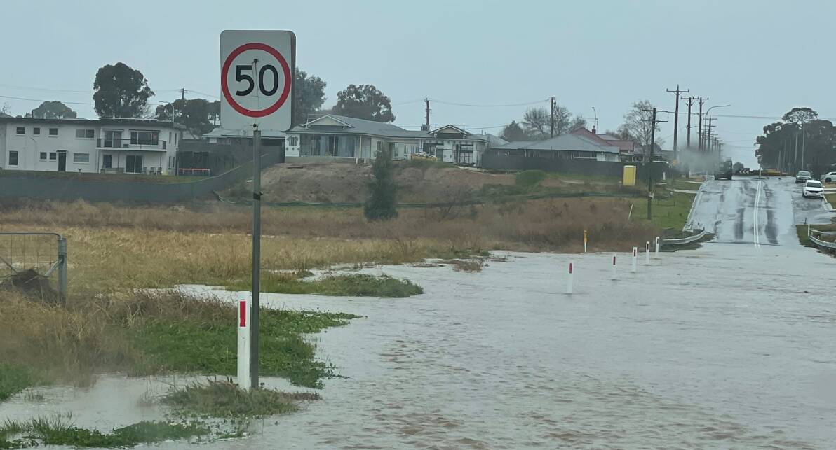 WET WEATHER: Water over Eleven Mile Drive near Saltram Creek on Thursday, August 4. Photo: SUPPLIED