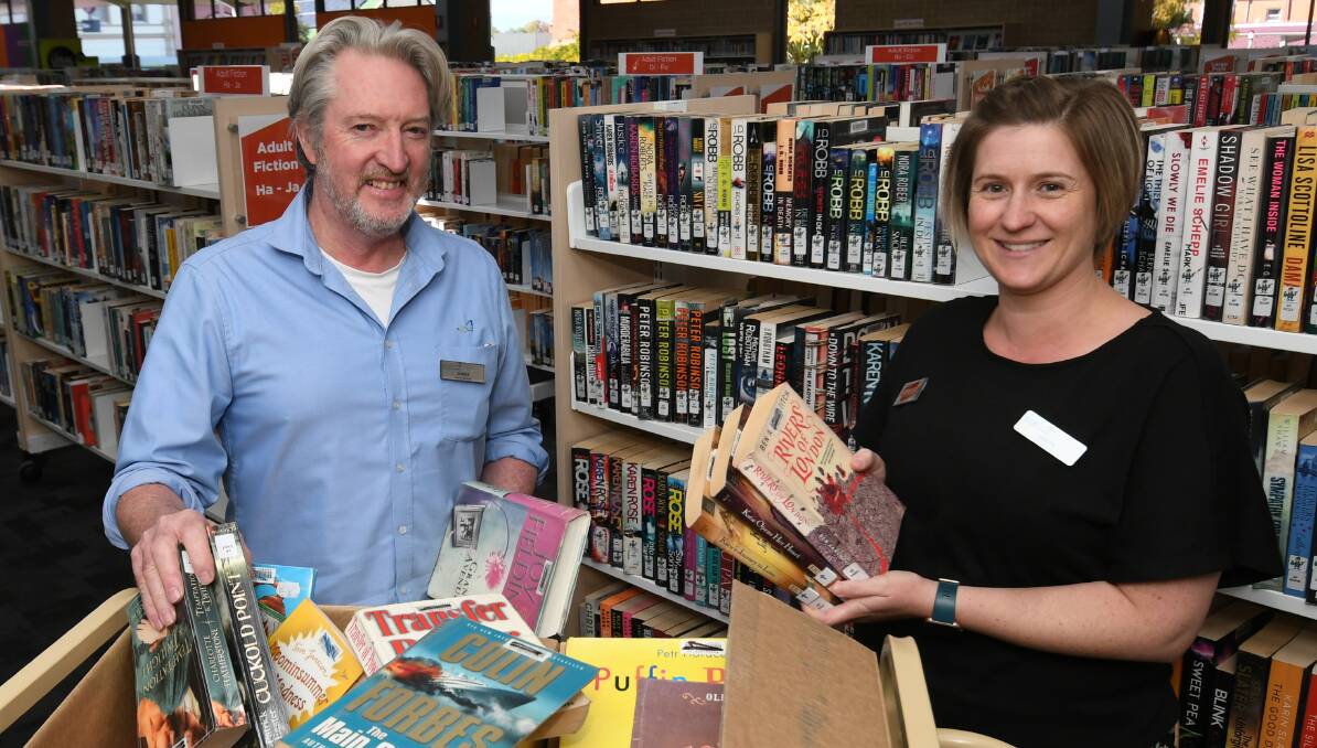 NEW INITIATIVE: Bathurst Library staff Shane Summerton and Loryn Adler with books to be recycled. Photo: CHRIS SEABROOK 041921cbooks