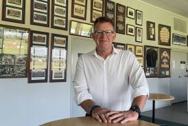 Bathurst Bulldogs president Phill Newton, in front of a host of old team photos. Picture by Bradley Jurd