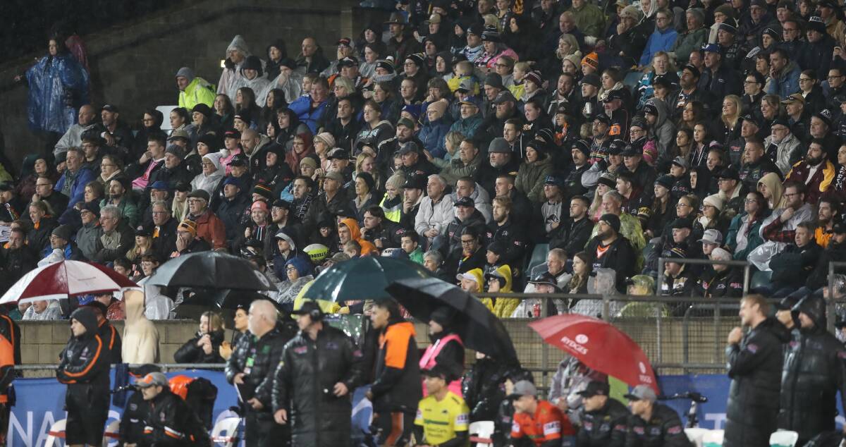 Heavy rain did not stop the fans packing out last year's NRL match in Bathurst. This year's match is expected to draw another big crowd. Pictures by Phil Blatch