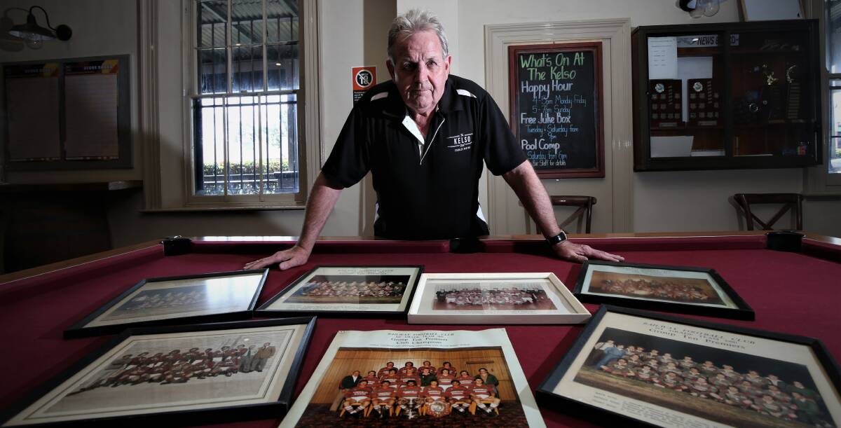 FLASHBACK: Former Railway player Robert Taylor with a collection of team photos from the 1980s. Photo: PHIL BLATCH 