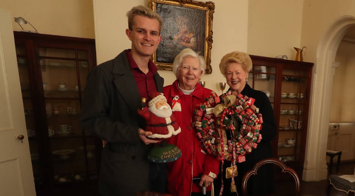 DINNER TIME: Charlie Hodgkin, Mary Warren and Susan Morris at Miss Traill's House ahead of the Christmas in July dinner on Saturday.