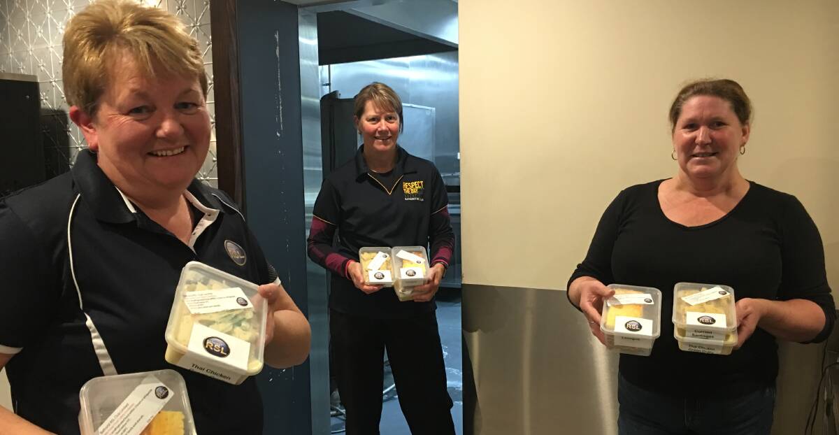 NO DINE-IN: Bathurst RSL chefs Miriam Muldon, Sue Reeves and Donna Kauer with takeaway meals that are now available. Theclub won't be opening for dine-in meals anytime soon though. Photo: BRADLEY JURD