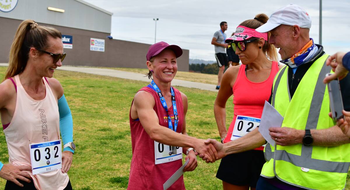 WINNER: Bathurst Half Marathon female winner Ash Corby is congratulated by volunteer Trevor Bayliss after Sunday's win. Photo: BRADLEY JURD
