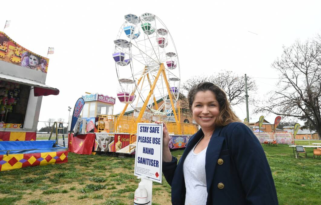 FUN TIME: Fun Fair event manager Jade Evans with some of the ready-to-go rides and stalls at the showground. Photo: CHRIS SEABROOK