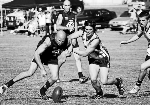 SOLID PERFORMER: Bathursts Alex Cuttiford (right) and Cowra rival Kim Reid tussle for the ball. Photo: DAMIEN JOHNSON 
