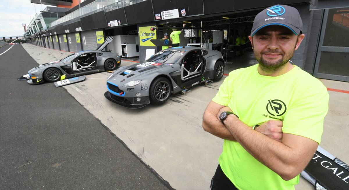 EARLY ARRIVAL: R-Motorsport team manager Bob Friend with their two Aston Martin Vantages, for the Bathurst 12 Hour. Photo:CHRIS SEABROOK 