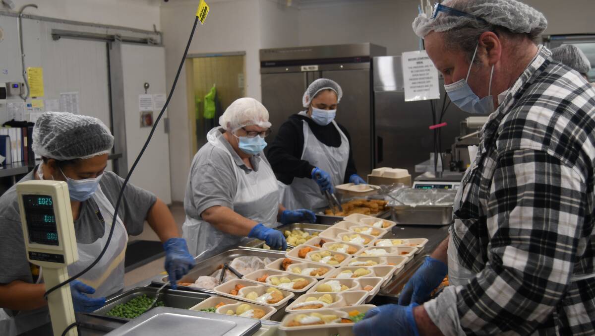 FUNDING BOPOST: Staff preparing food packages at the Bathurst Meals on Wheels kitchen on Watt Drive. The centre has had major upgrades finished. Photo: BRADLEY JURD