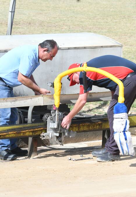 ISSUE: Bathurst Greyhound Racing Club works quickly to fix a mechanical issue with the artificial lure at Kennerson Park on Monday. Photo: CHRIS SEABROOK