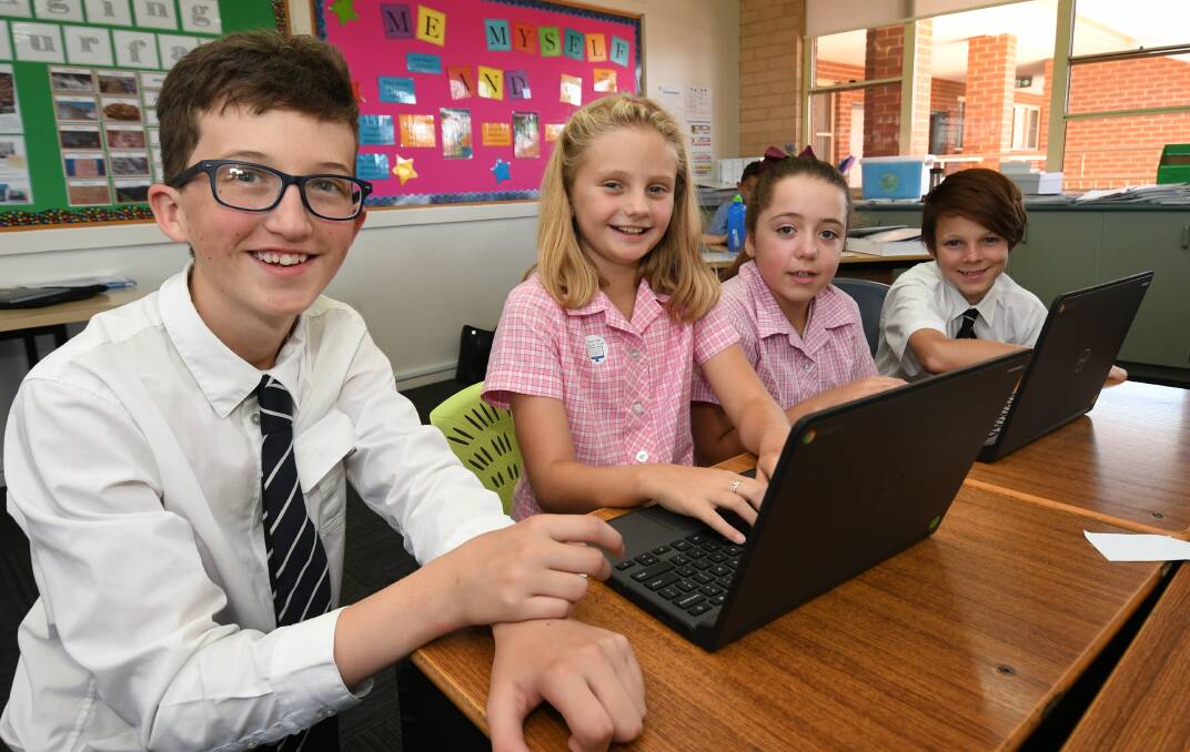 MENTORING: St Stanislaus' College Year 8 students Liam Gildea (left) and Mitchell Peters with Cathedral School Year 4 students Bella Weal and Kaylee Dowling. Photo: CHRIS SEABROOK 021219cmentors1