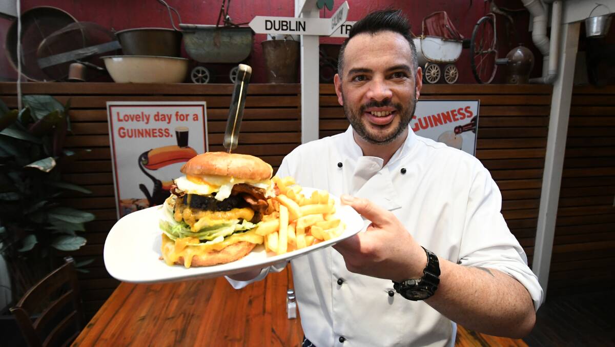 BEST IN BATHURST? Jack Duggan's Irish Pub head chef Terry Thuell with the the Foxy Burger. Photo: CHRIS SEABROOK 123119cduggans1