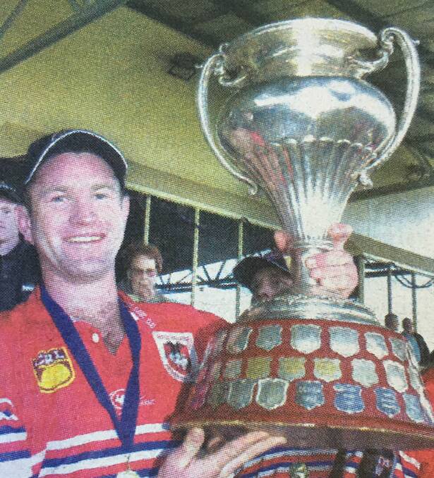 Mudgee captain Warick Colley win the Group 10 premiership trophy.