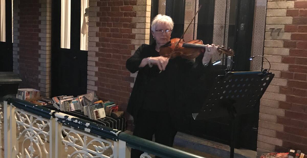 Monica Morse plays the Last Post on her viola in Piper Street. Photo: SUPPLIED