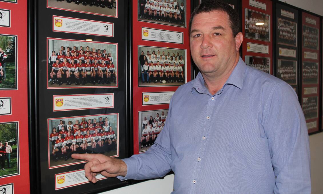 REMEMBERING: Panthers Bathurst general manager John Fearnley, with his 1997 team photo for the Bathurst Penguins. Photo: BRADLEY JURD