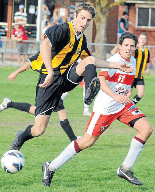 TOO GOOD: Lithgow player Scott Hookham blocks an attempted shot at goal by CSU in its 3-2 win. Photo: CHRIS SEABROOK 