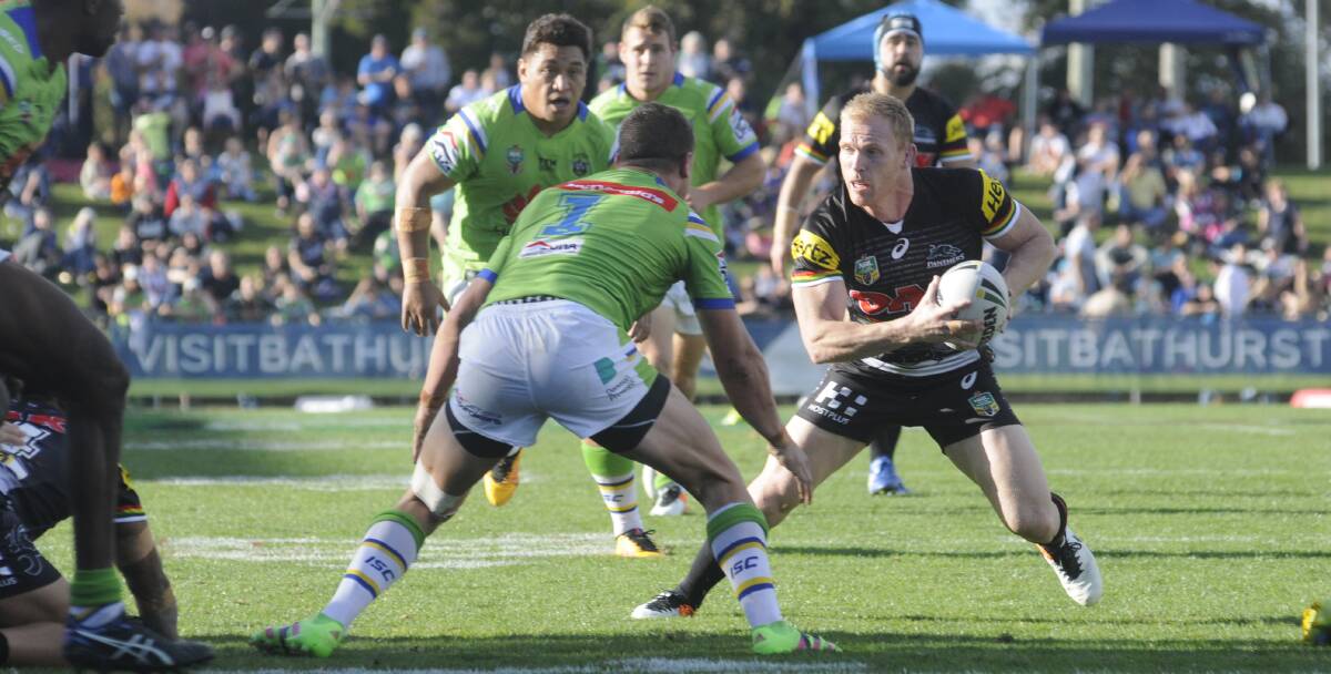 ATTACK: Panthers' Peter Wallace takes on Raiders' Jack Wighton last year.