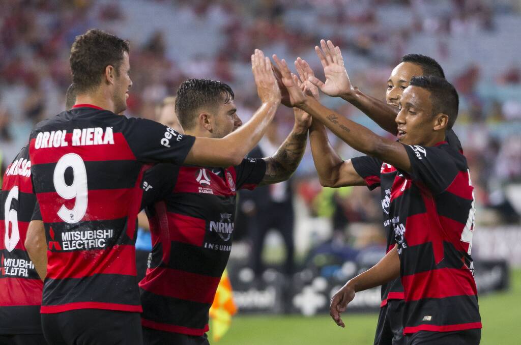 Oriol Riera of the Western Sydney Wanderers (left) celebrates a goal. He and his Wanderers teammates are set to be in Bathurst for community engagement clinics. 