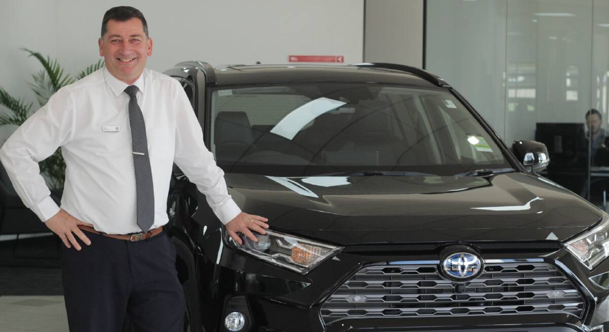 IN DEMAND: Bathurst Toyota sales consultant Paul Welsh, with a RAV4 Hybrid, Australia's top-selling car in August. Photo: BRADLEY JURD