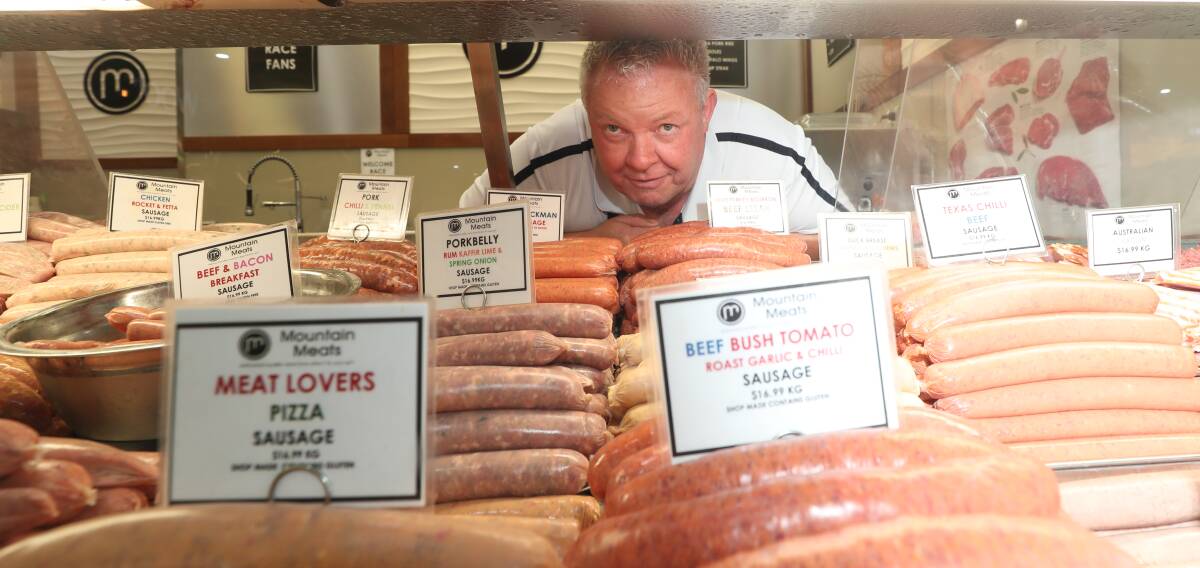 SNAGS: Mountain Meats owner Paul Smith, with some of the 24 flavours on offer at the butcher. Photo: PHIL BLATCH