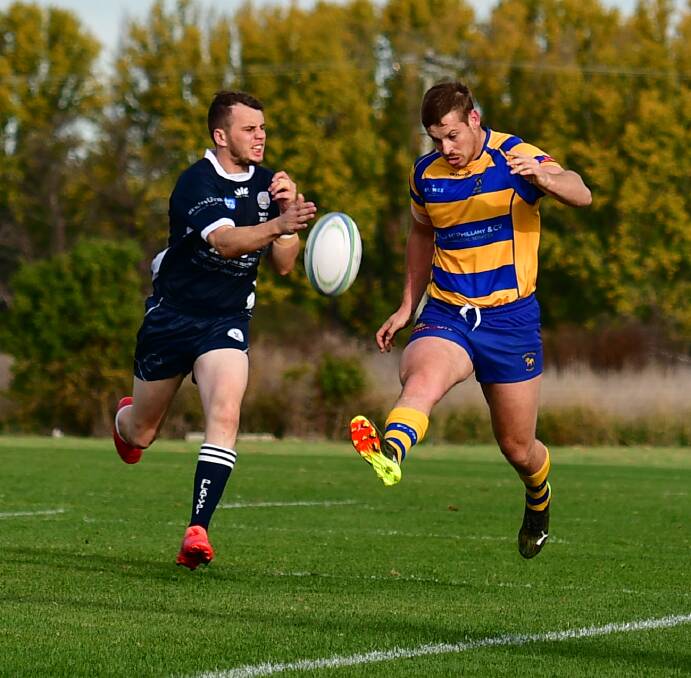 BOOT TO BALL: Adam Plummer kicks the ball in his team's win over Forbes last Saturday. Photo: ALEXANDER GRANT