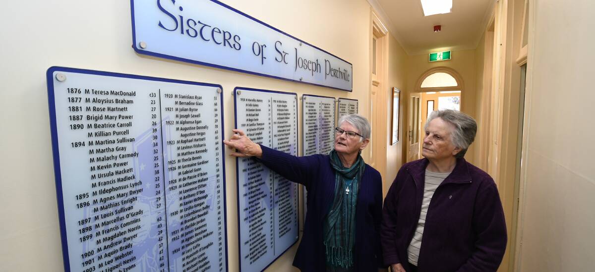 TOURS: Sister Mary Murphy and Sister Maureen Sanderson looking at a panel detailing the sisters who were at the Perthville since 1876. 