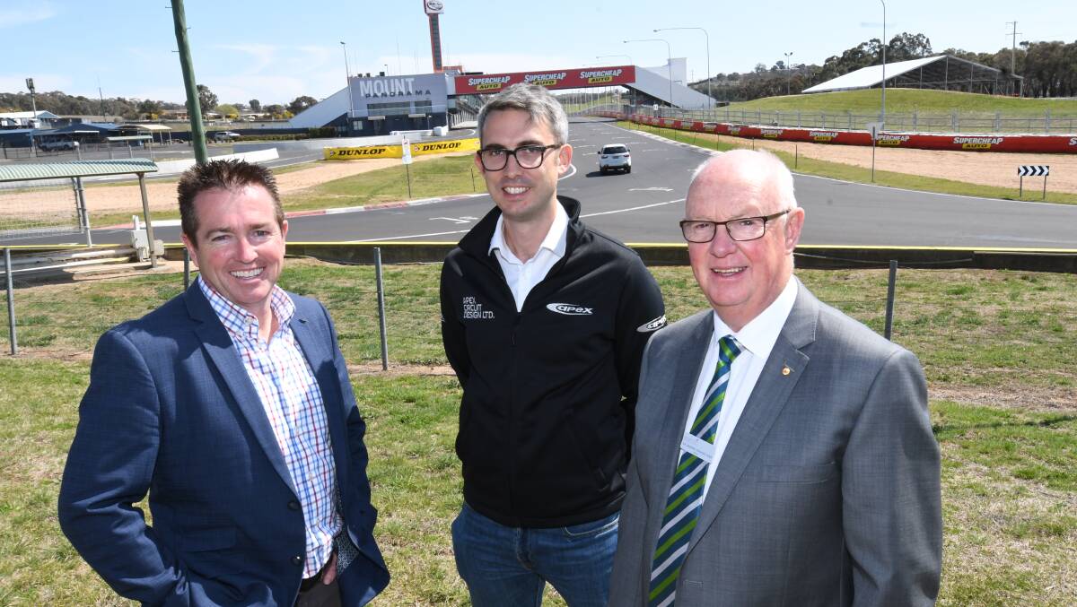 CHALLENGE: Member for Bathurst Paul Toole, Apex Circuit Design design director Dafydd Broom and Bathurst mayor Graeme Hanger, at the Mount Panorama Circuit on Wednesday. Photo: CHRIS SEABROOK 091218capex1