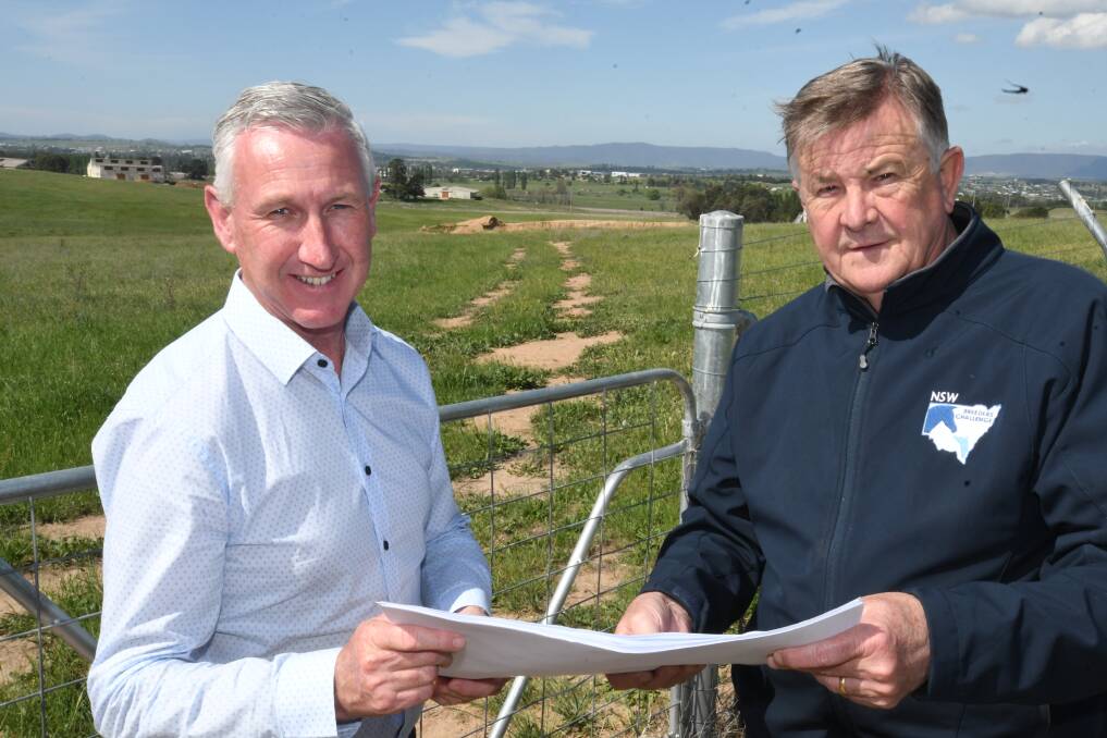 WORK: Bathurst Harness Racing Club CEO Danny Dwyer and Harness Racing NSW board member Peter Nugent. Behind them is the land that will be used to build a new training facility. Photo: CHRIS SEABROOK