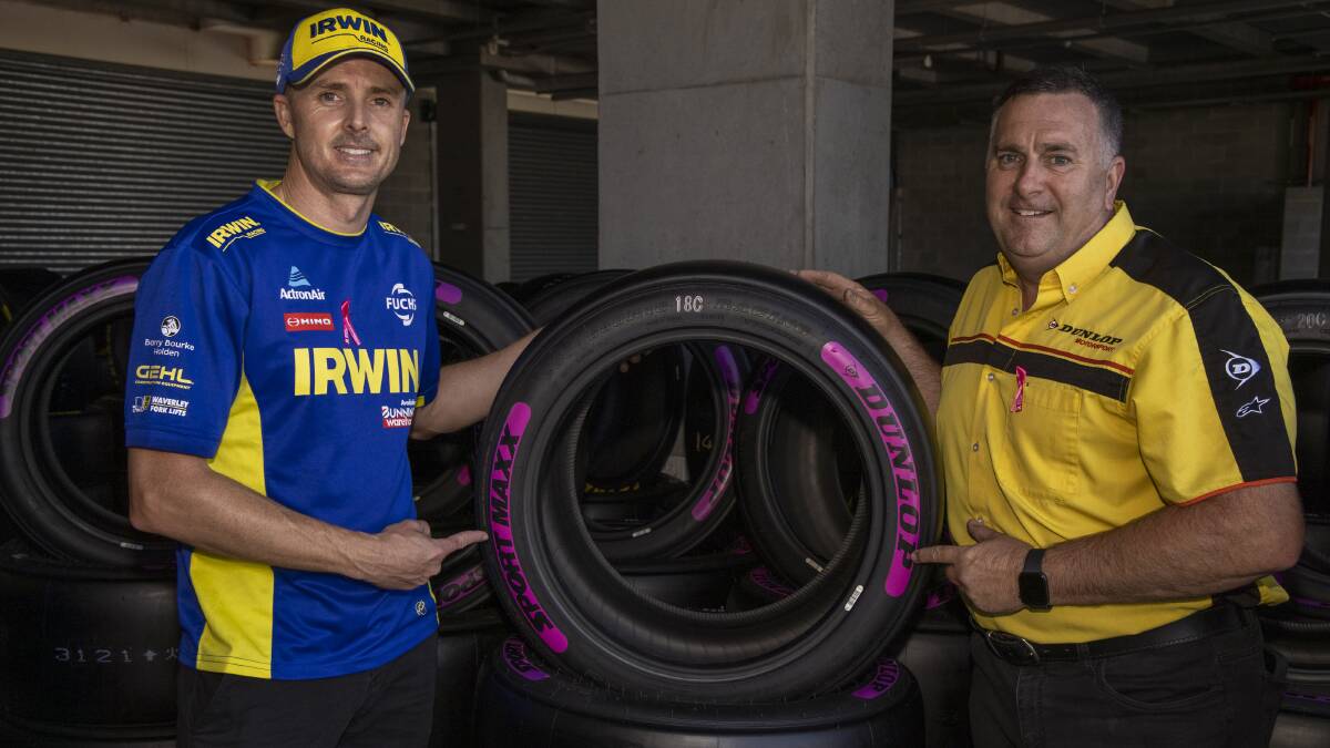 GOING PINK: Irwin Racings Mark Winterbottom and Dunlop operations manager Kevin Fitzsimons, who has hand applied pink Dunlop lettering to each and every tyre. 
