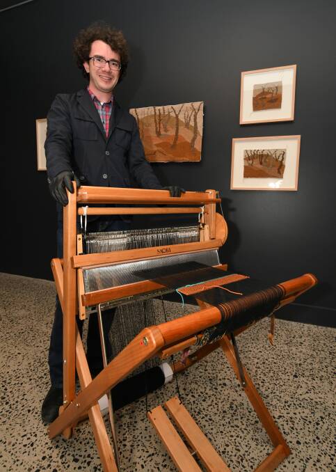 SHOWTIME: Bathurst Regional Art Gallery's Julian Woods with Heather Dunn's Saori weaving loom, from a new exhibition starting on Friday. Photo: CHRIS SEABROOK