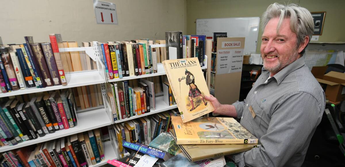 GRAB A BOOK: Cataloguer Shane Summerton sorting out books for the Bathurst Library's monthly sale. Photo: CHRIS SEABROOK